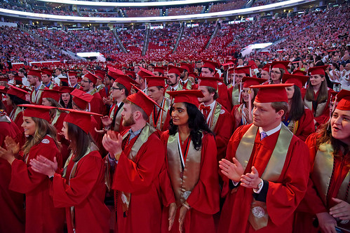 Graduates applaud their official conferment of their degrees.