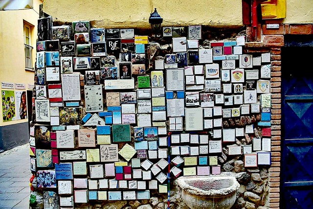 A piece of wall in Albenga/Liguria with many metal signs