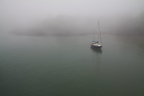 ilfracombe harbour boat maritime seafog foggy mist haar water calm quiet shrouded mysterious sailingboat anchored atanchor harboured greenwater ocean coast coastal northdevon canon eos50d tamron 1750mm landscape seascape ripples shore uk