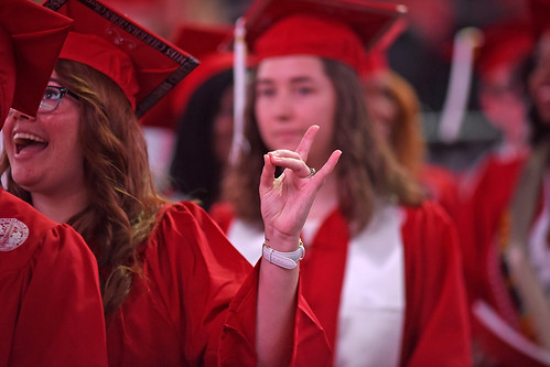 Graduate flashes wuf hands as she enters PNC Arena.