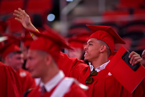 Graduate waves to family as he enters PNC Arena.